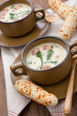 Close up of creamy Broccoli Chowder Soup with beacon, potato, and broccoli. Cheddar rosemary breadsticks.の写真素材
