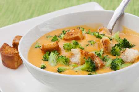 Close up of hot delicious broccoli - cheddar cheese soup with garlic croutons.の写真素材