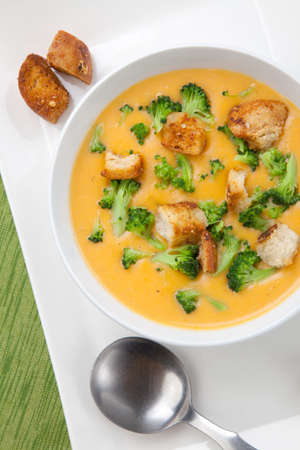 Close up of hot delicious broccoli - cheddar cheese soup with garlic croutons.の写真素材
