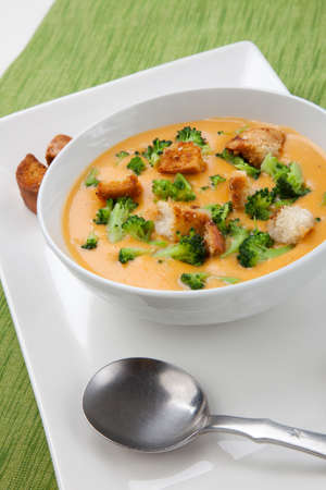 Close up of hot delicious broccoli - cheddar cheese soup with garlic croutons.の写真素材