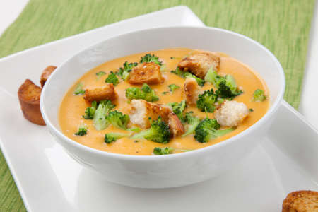 Close up of hot delicious broccoli - cheddar cheese soup with garlic croutons.の写真素材