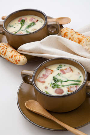 Close up of creamy Broccoli Chowder Soup with beacon, potato, and broccoli. Cheddar rosemary breadsticks.の写真素材