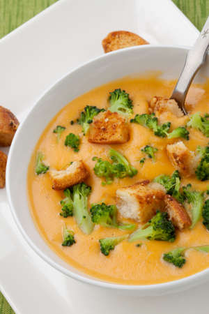 Close up of hot delicious broccoli - cheddar cheese soup with garlic croutons.の写真素材