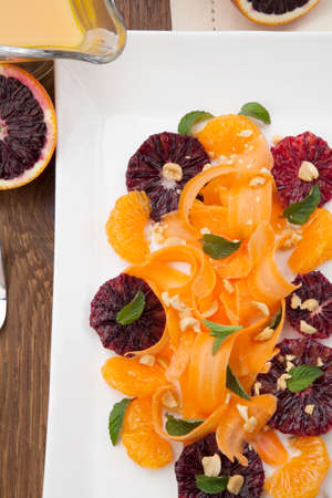 Closeup of a plate of blood oranges, carrots, and tangerines salad with peanut-mint dressing.の写真素材