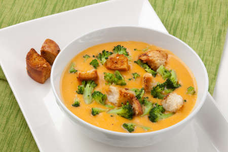 Close up of hot delicious broccoli - cheddar cheese soup with garlic croutons.の写真素材