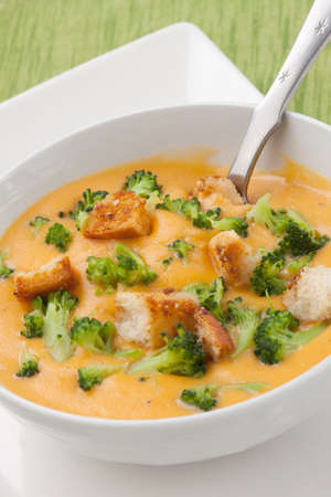 Close up of hot delicious broccoli - cheddar cheese soup with garlic croutons.の写真素材