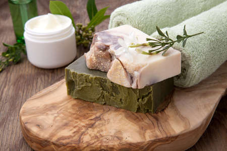Spa set - assorted handmade organic soap, fresh Jasmine flowers, and jar of moisturizing face cream for spa treatment.の写真素材