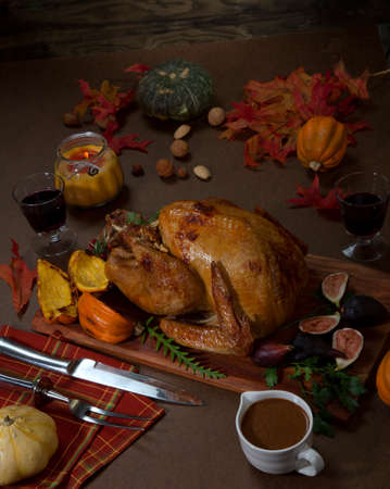 Garnished traditional roasted turkey for Thanksgiving, garnished with roasted winter squash, cranberry, nuts, and fresh herbs.の写真素材