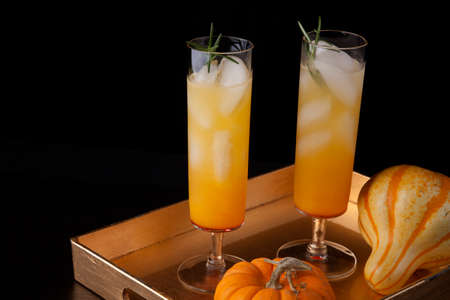 Closeup of Pear Sparkler cocktail and mini pumpkins on a tray. Fall Drinks series.の写真素材