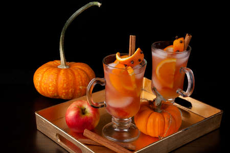 Closeup of Spicy Apple Cider on a tray with mini pumpkinsの写真素材