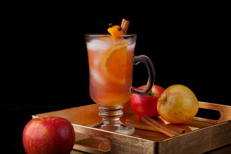 Closeup of Spicy Apple Cider on a tray with mini pumpkins, fresh apples, and cinnamon sticks. Fall Drinks series.の写真素材
