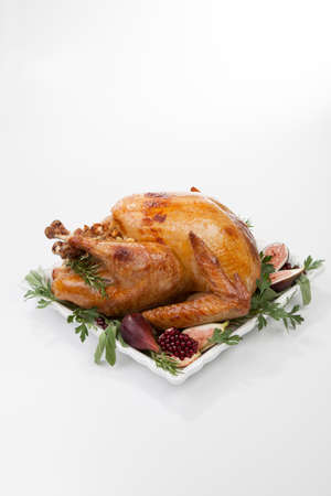 Garnished traditional roasted turkey, garnished with fresh figs, pomegranate, and herbs.の写真素材