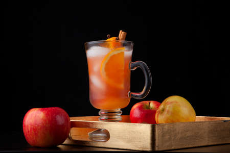 Closeup of Spicy Apple Cider on a tray with mini pumpkins, fresh apples, and cinnamon sticks. Fall Drinks series.の写真素材