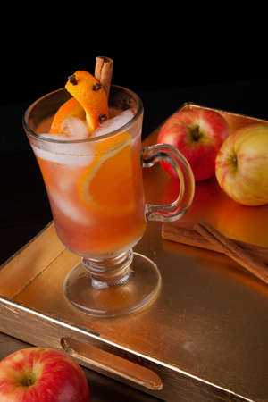 Closeup of Spicy Apple Cider on a tray with mini pumpkins, fresh apples, and cinnamon sticks. Fall Drinks series.の写真素材