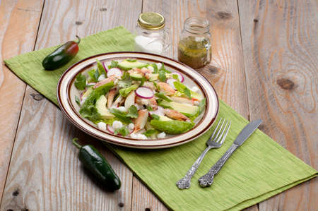 Fusion of Mexican cuisine and a traditional seafood crab salad. Closeup of Crab Posole Salad with fresh cooked Dungeness crab meat, avocado, radish, Romaine lettuce, and white hominy.の写真素材