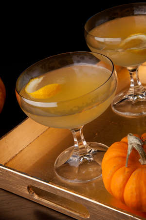 Closeup of Champagne Cocktail on a tray with mini pumpkins. Fall Drinks series.の写真素材