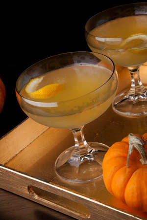 Closeup of Champagne Cocktail on a tray with mini pumpkins. Fall Drinks series.の写真素材