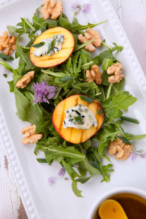 Closeup of blue cheese and peach salad with walnut and arugula. Freash peaches.の写真素材