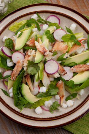 Fusion of Mexican cuisine and a traditional seafood crab salad. Closeup of Crab Posole Salad with fresh cooked Dungeness crab meat, avocado, radish, Romaine lettuce, and white hominy.の写真素材