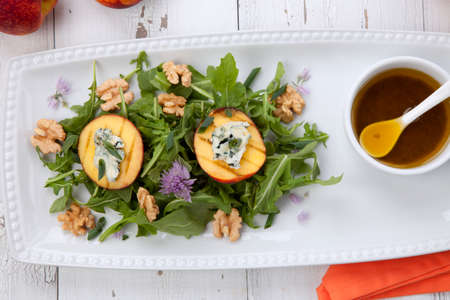 Closeup of blue cheese and peach salad with walnut and arugula. Freash peaches.の写真素材