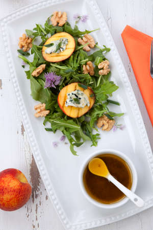 Closeup of blue cheese and peach salad with walnut and arugula. Freash peaches.の写真素材