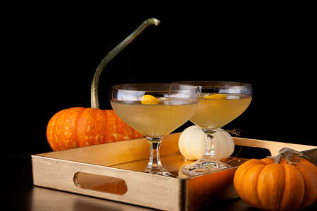Closeup of Champagne Cocktail on a tray with mini pumpkins. Fall Drinks series.の写真素材