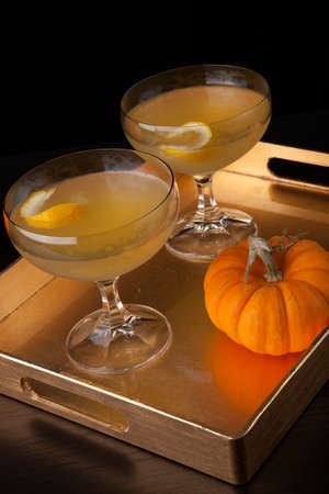 Closeup of Champagne Cocktail on a tray with mini pumpkins. Fall Drinks series.の写真素材