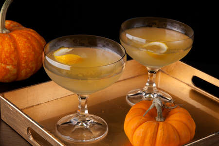Closeup of Champagne Cocktail on a tray with mini pumpkins. Fall Drinks series.の写真素材