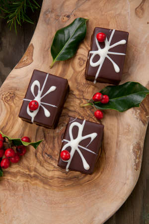 Traditional Christmas chocolate candy, Christmas ornaments, decorations, and red berries.の写真素材