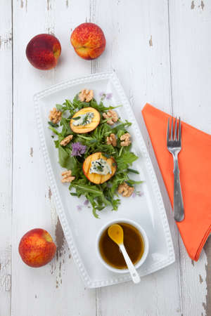 Closeup of blue cheese and peach salad with walnut and arugula. Freash peaches.の写真素材