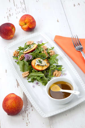 Closeup of blue cheese and peach salad with walnut and arugula. Freash peaches.の写真素材