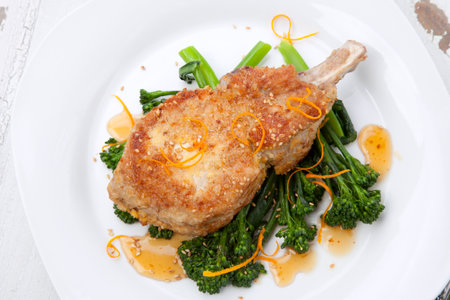 Closeup of sesame-crumbed pork chops with asian greens.の写真素材
