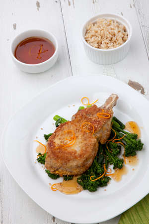 Closeup of sesame-crumbed pork chops with asian greens.の写真素材
