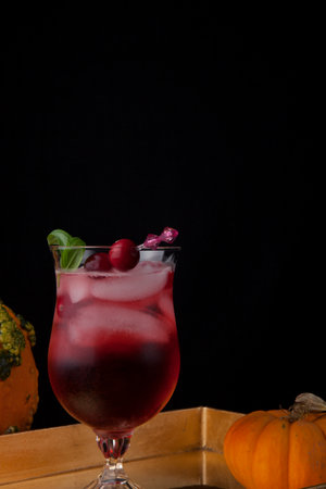 Closeup of Whiskey-Cranberry cocktail on a tray with mini pumpkins. Fall Drinks series.の写真素材