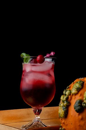 Closeup of Whiskey-Cranberry cocktail on a tray with mini pumpkins. Fall Drinks series.の写真素材