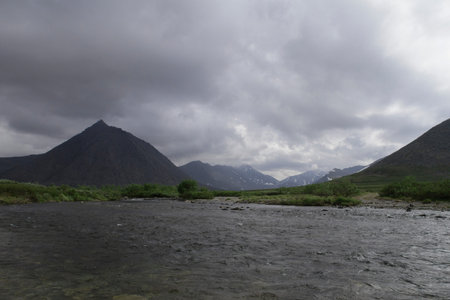 mountain lake with snowy tops of mountains on the highの写真素材