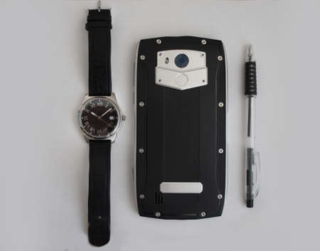 male, black pen, smartphone and clock on white backgroundの写真素材