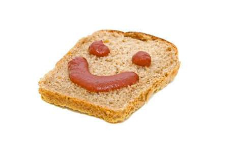 smiley face on a piece of black breadの写真素材