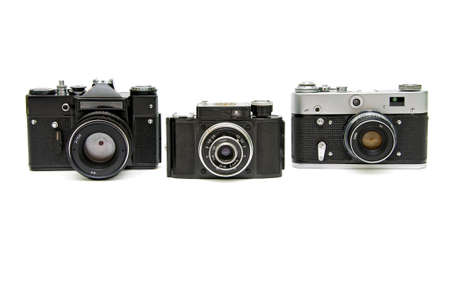 three old analog camera on a white backgroundの写真素材