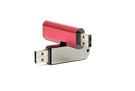 Flash drives in different colors closeup on white background