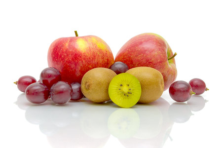 Fresh juicy apples, kiwis and grapes on a white background close-upの写真素材