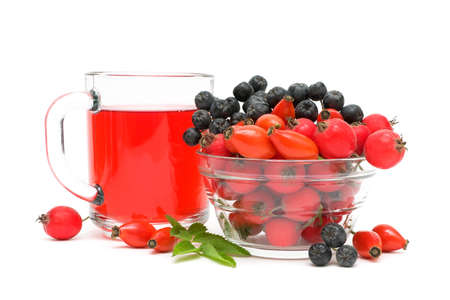 cup of tea with rose hips and different ripe berries on a white background close-upの写真素材