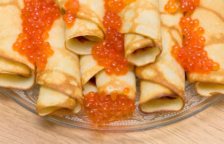 pancakes with red caviar on glass plate close-upの写真素材