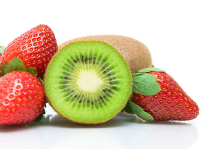 half kiwi and juicy strawberries close-up on white backgroundの写真素材