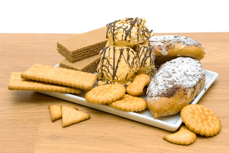different confectionery - cakes, waffles and cookies in a white plate