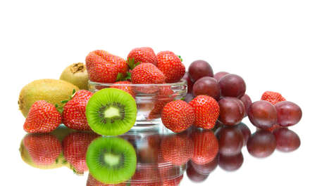 ripe juicy berries. strawberries, kiwi and dark grapes on a white background with reflection.の写真素材
