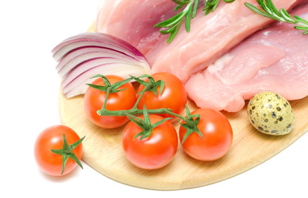 ripe cherry tomatoes and raw meat close-up on a cutting board on a white background. horizontal photo.の写真素材