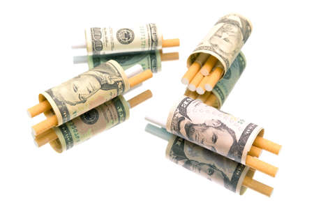 money and cigarettes on a white background. expensive habitの写真素材