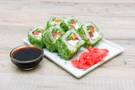 Japanese cuisine. savory rolls, pickled ginger on a plate and soy sauce on a wooden table. horizontal photo.の写真素材