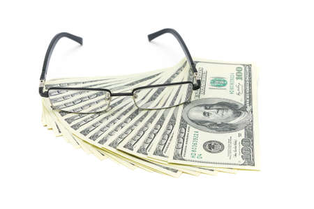 usa banknote denomination of 100 dollars and glasses isolated on white background. horizontal photo.の写真素材